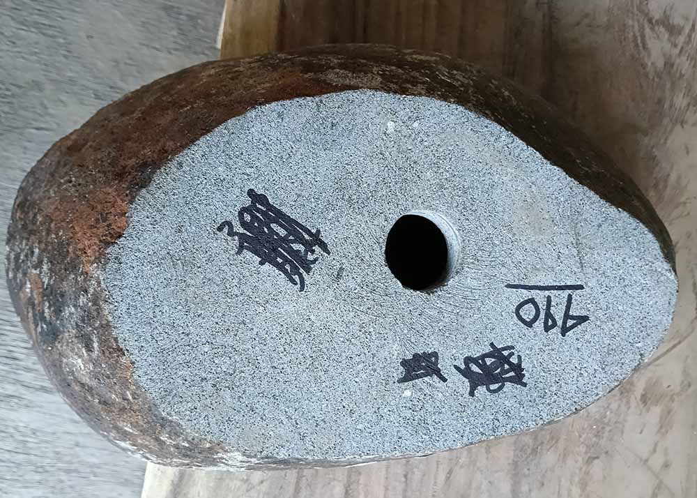 Underside of handcrafted sink 6440-4831 showing raw stone base and drain hole