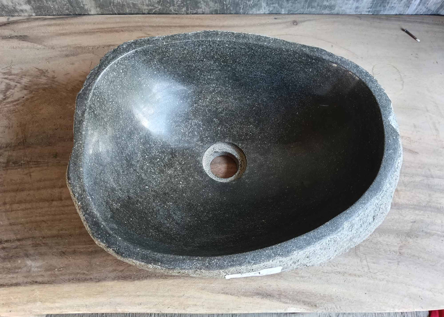 Top view of handcrafted river stone sink 6452-4536 with smooth dark gray basin