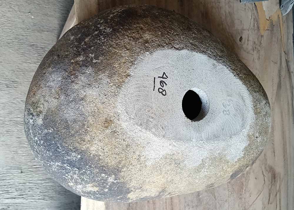 Underside of stone sink 6468-4634 with raw texture and centered drain