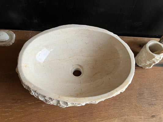 Compact beige marble bathroom vessel sink BMS-010 with a rough chiseled stone exterior