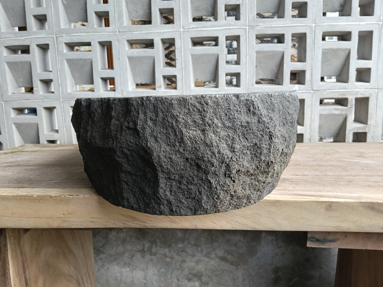 Right side perspective of handcrafted dark gray stone sink