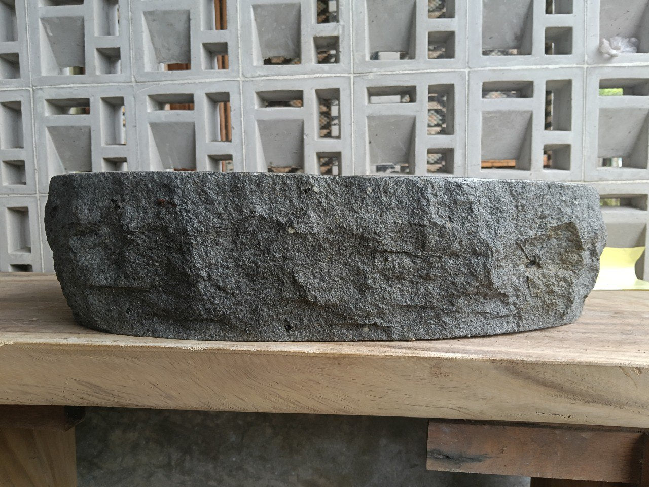 Left side perspective of oval andesite basin polished interior