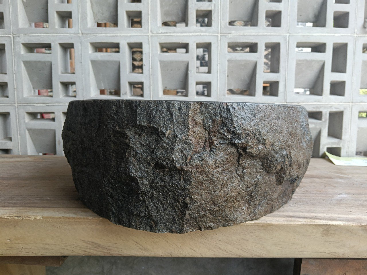 Left side perspective of oval andesite basin polished interior