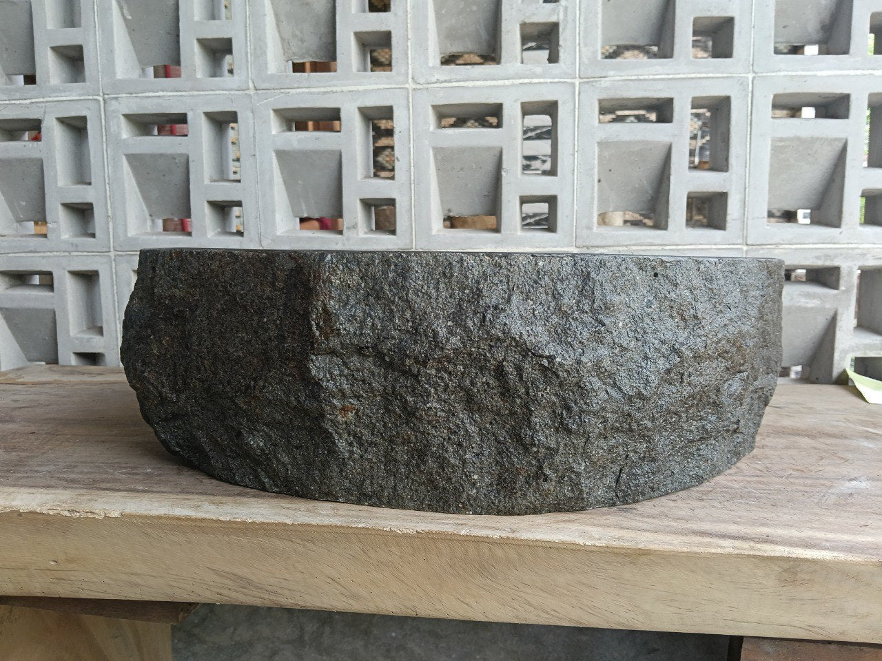 Right side perspective of handcrafted dark gray stone sink