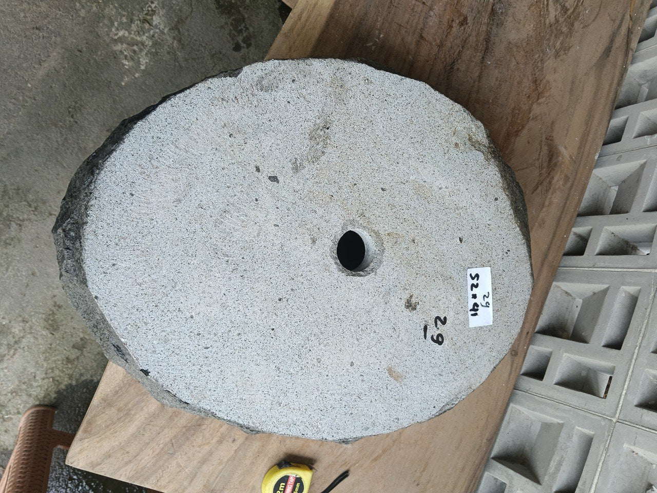 Bottom view of oval andesite stone sink with drain hole