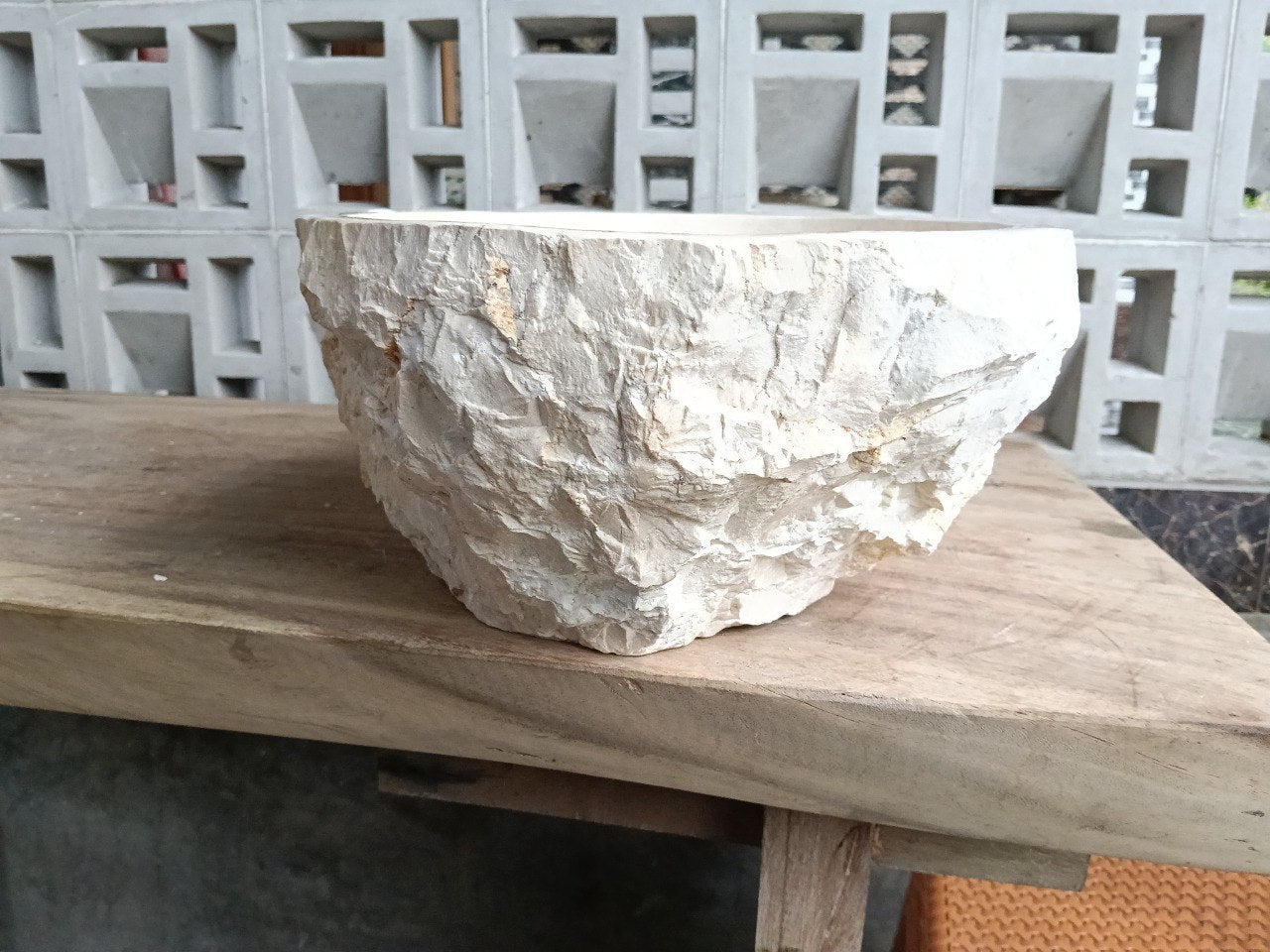Back view showing split-rock exterior of beige marble sink