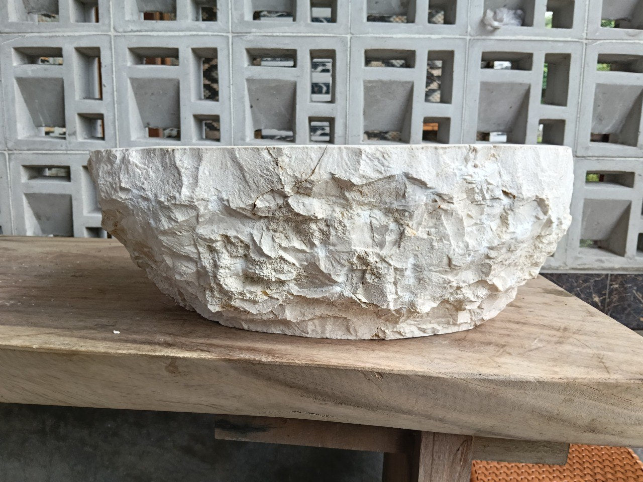 Left side perspective of polished oval beige marble basin