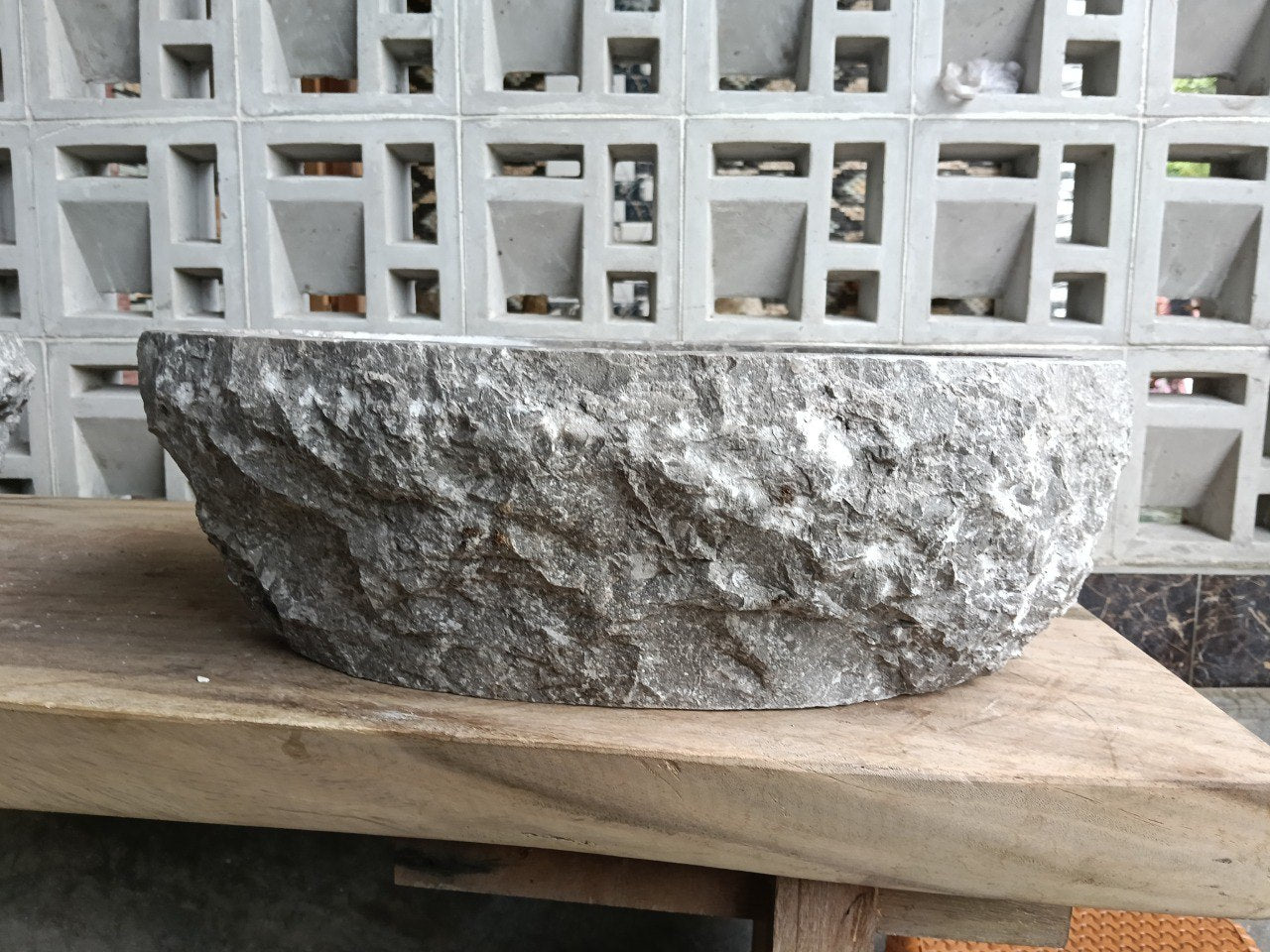 Left side perspective of oval polished gray marble basin