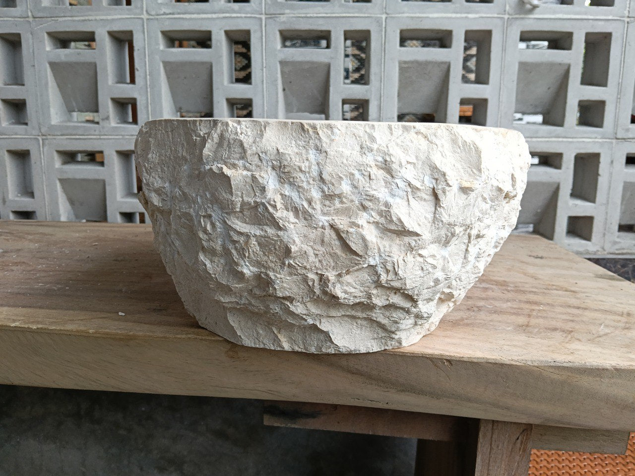 Left side perspective of oval polished beige marble basin