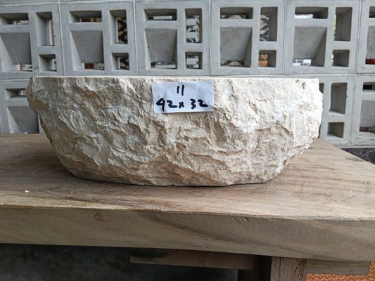 Front view of handcrafted oval beige marble bathroom sink