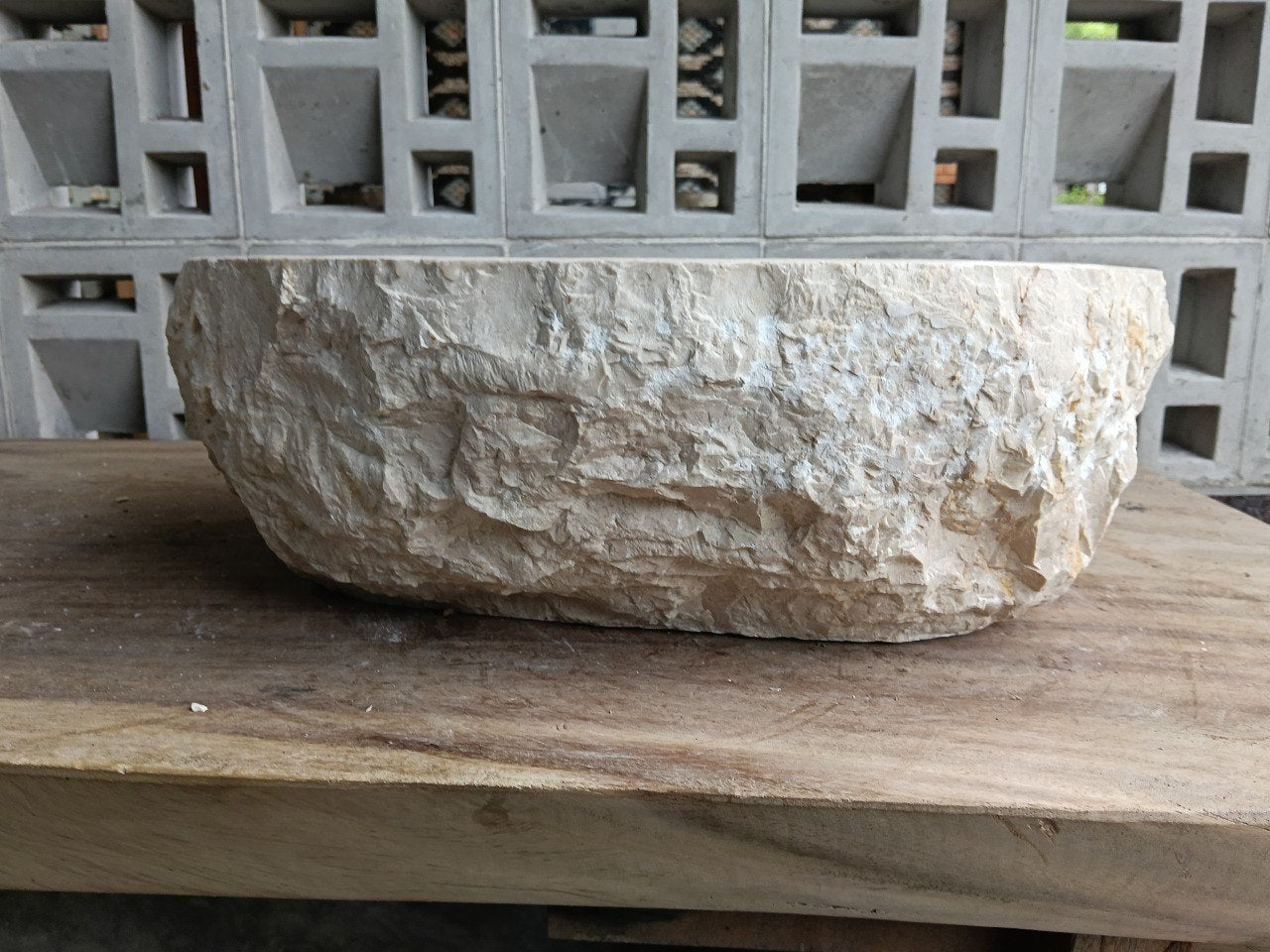 Back view showing natural split-rock exterior of beige marble sink