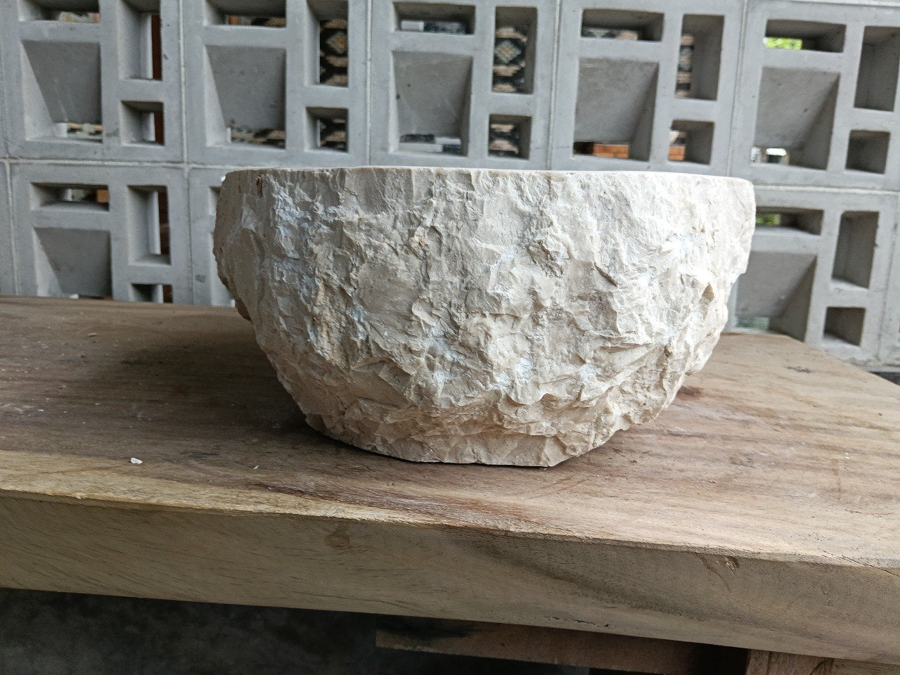 Left side perspective of oval polished beige marble basin