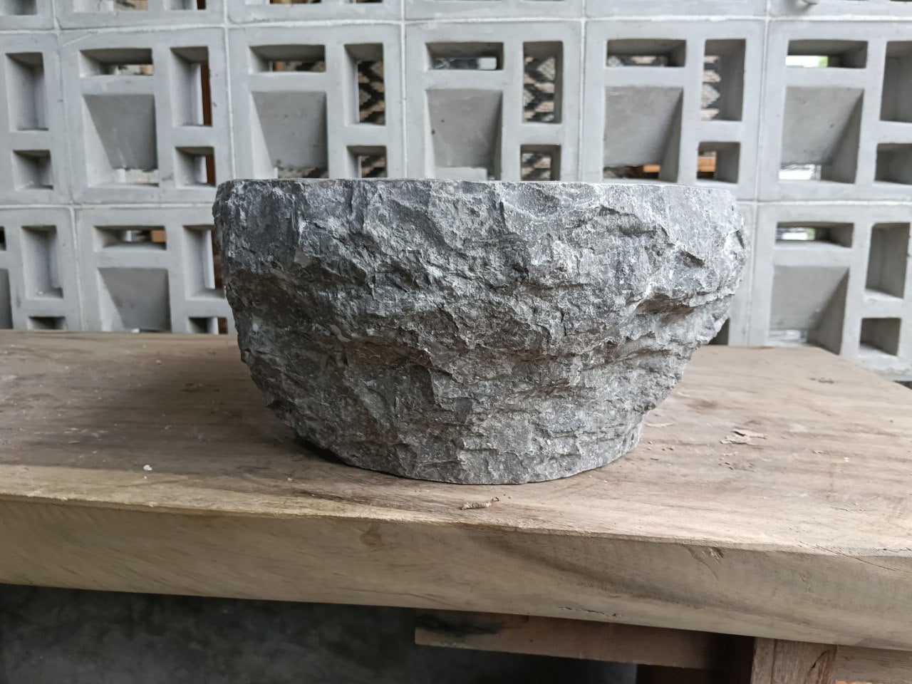 Back view showing rugged split-rock exterior of gray marble sink