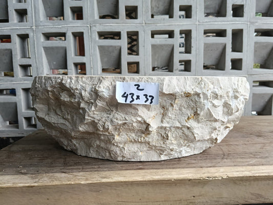 Front view of handcrafted beige marble bathroom sink