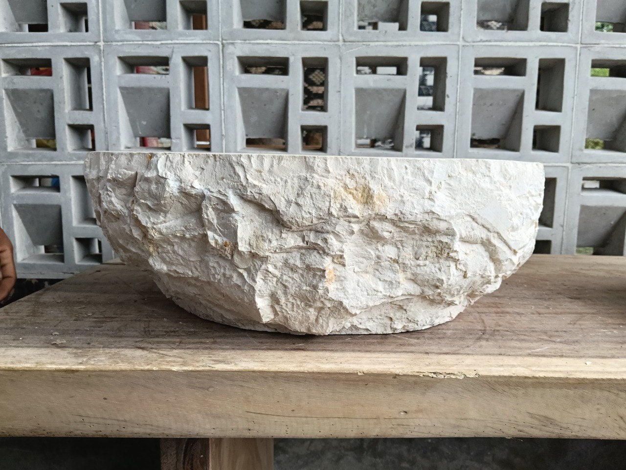 Left side perspective of oval beige marble basin