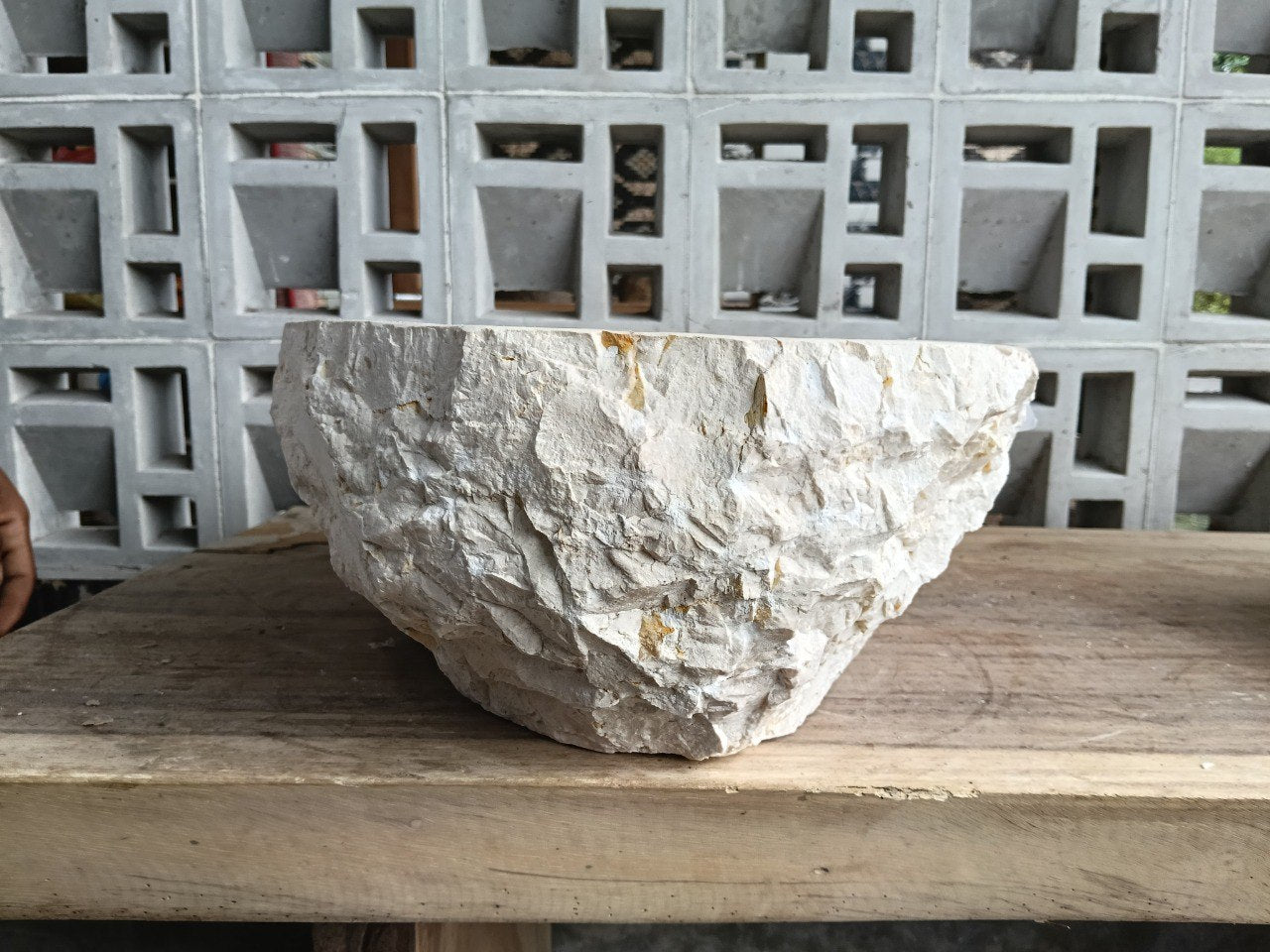 Right side perspective of handcrafted oval beige marble sink