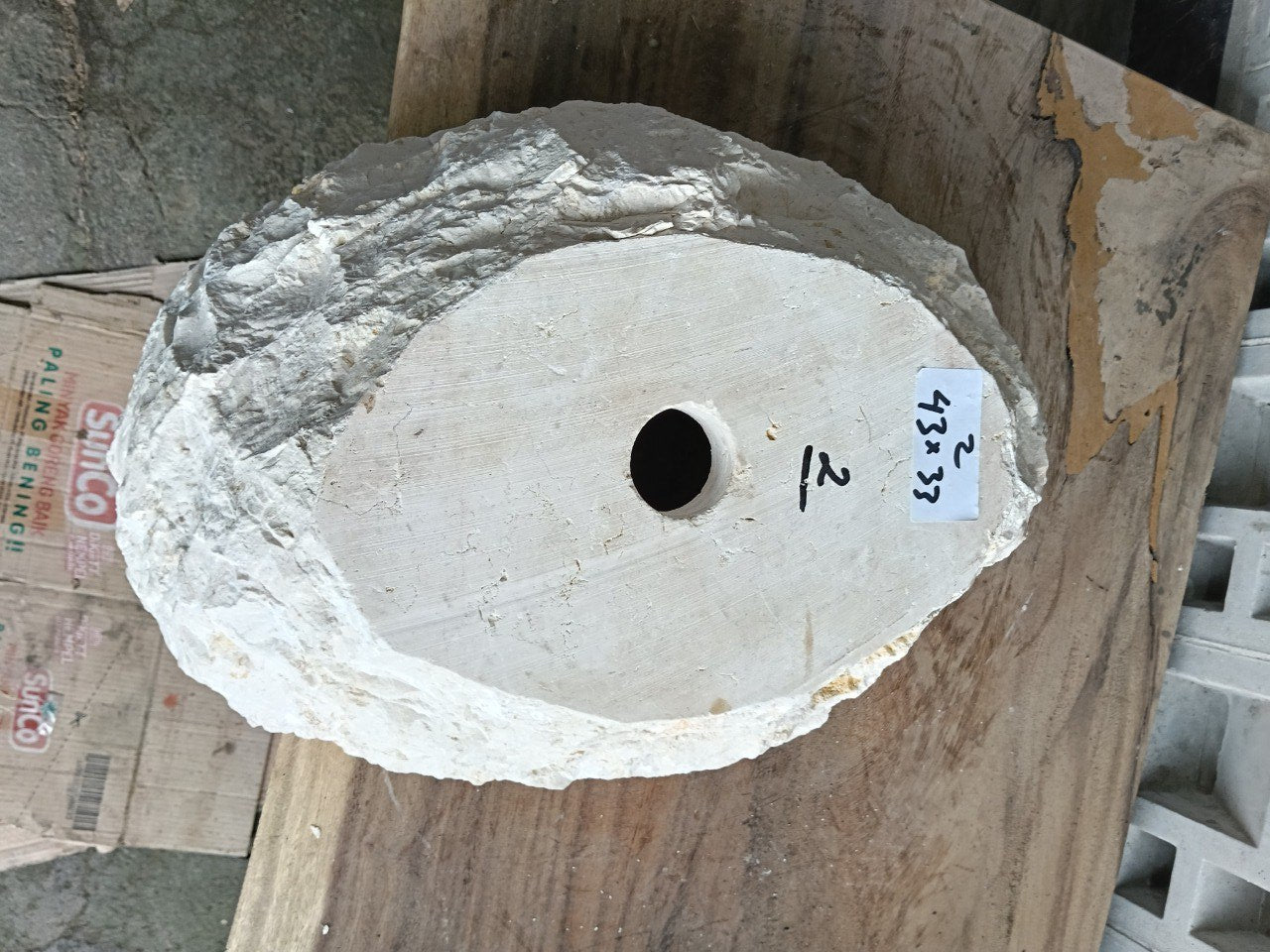 Bottom view of natural beige marble sink with drain hole