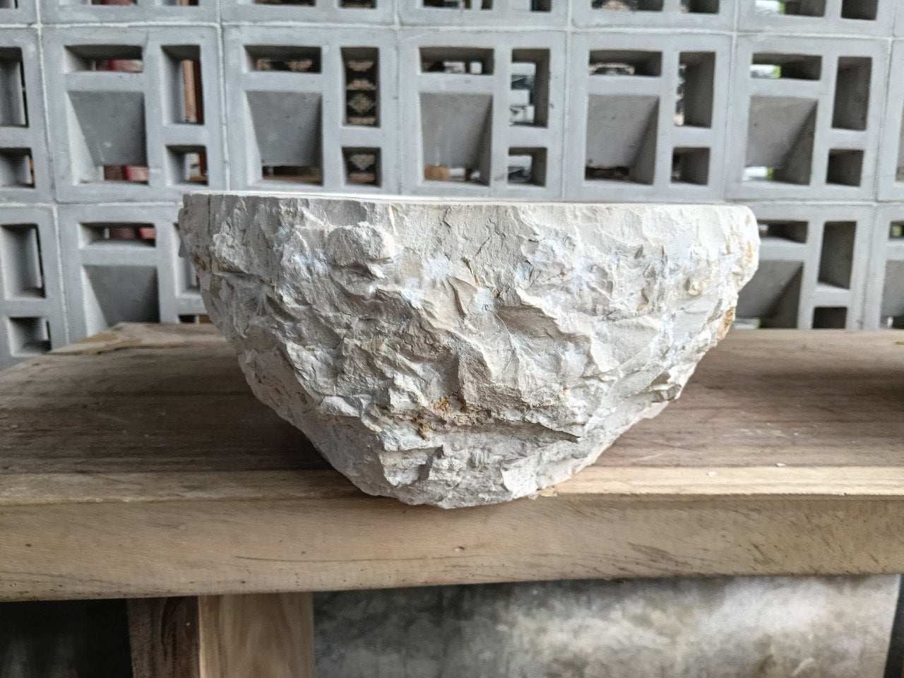 Back view showing natural split-rock exterior of beige marble sink