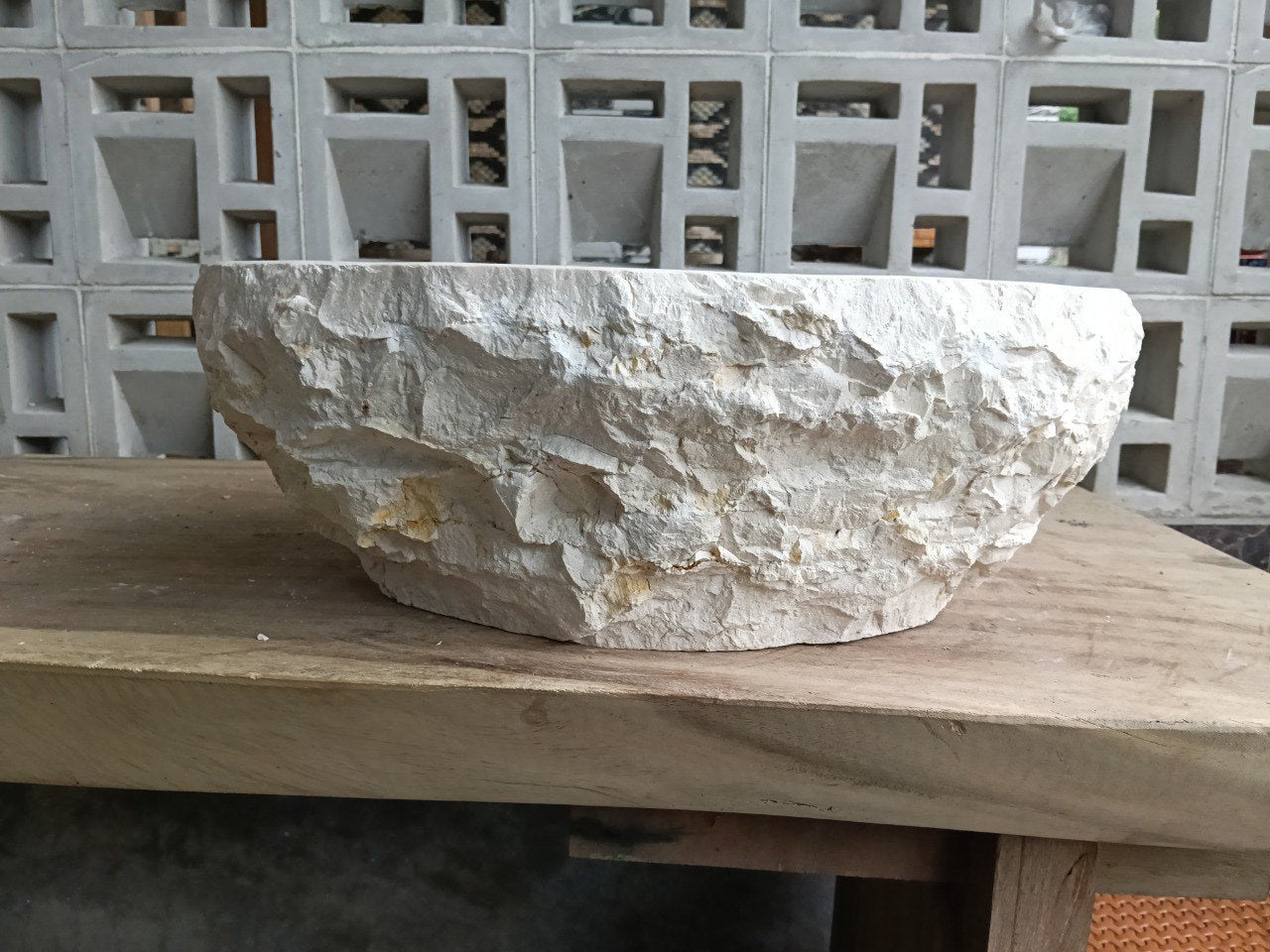 Left side profile of beige marble oval sink