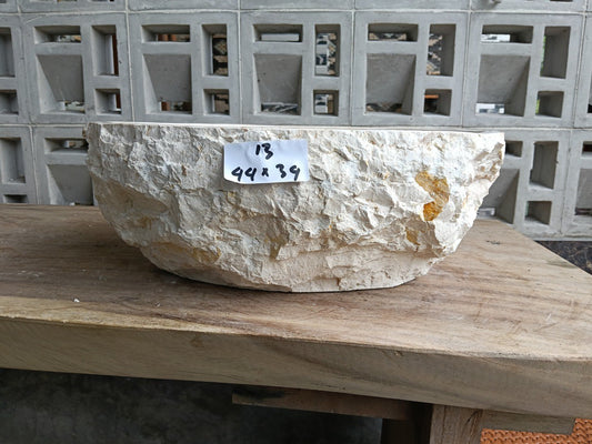 Front view of handcrafted beige marble bathroom basin