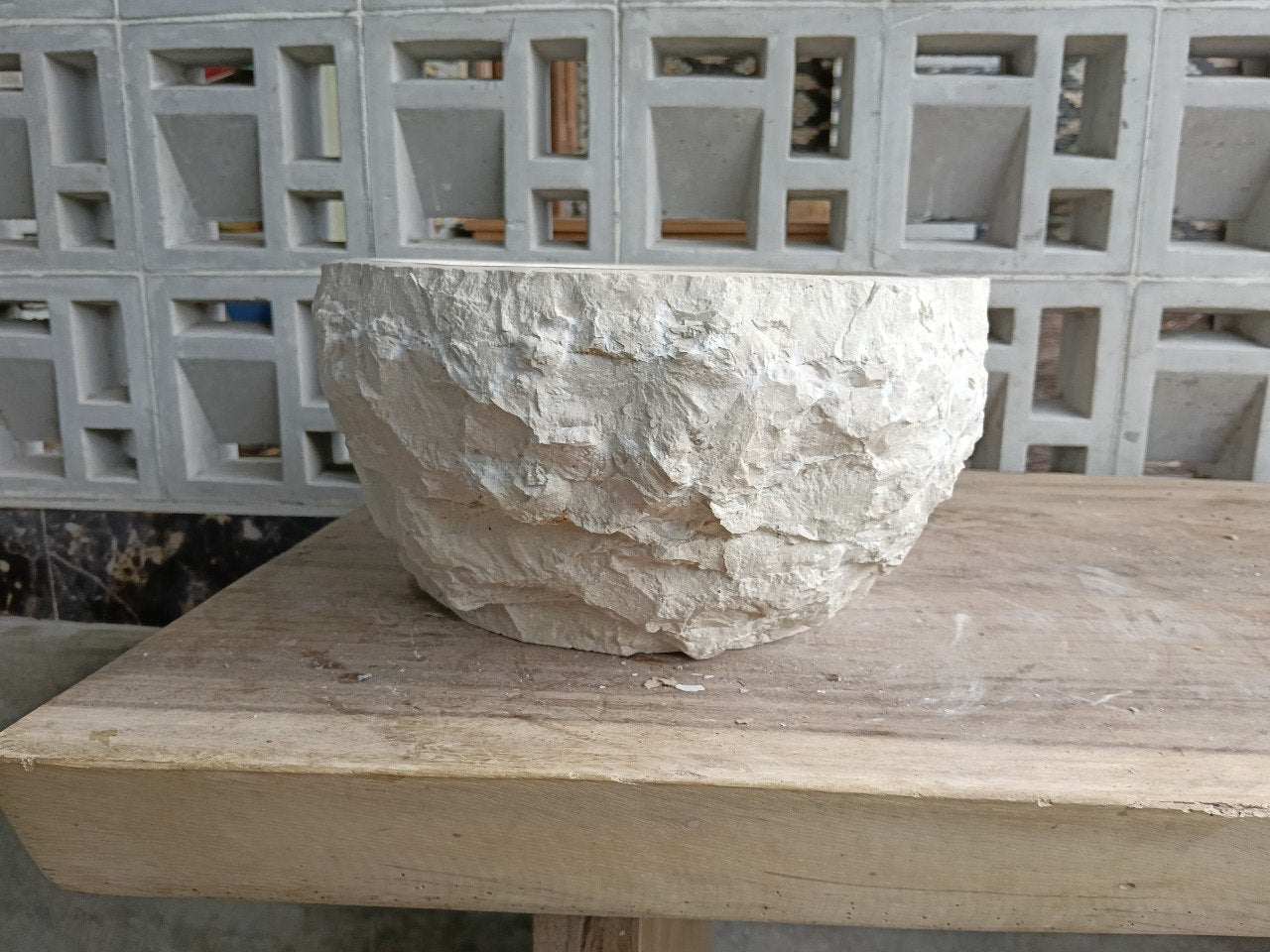 Left side profile of beige marble bathroom sink