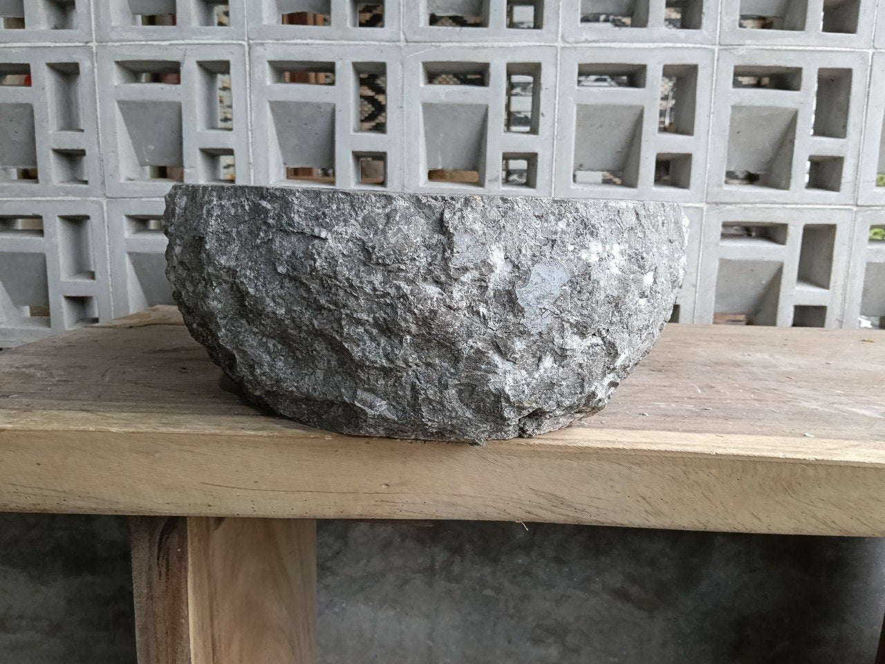 Right side view of oval gray marble stone sink
