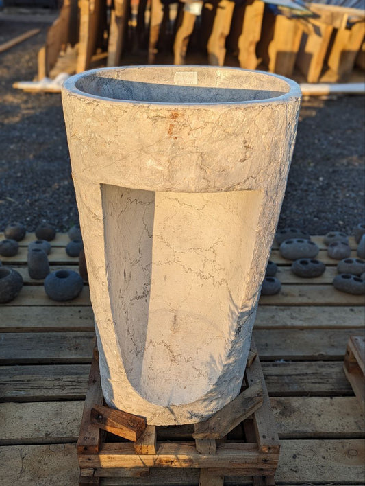 Side angle of natural marble pedestal sink in gray finish