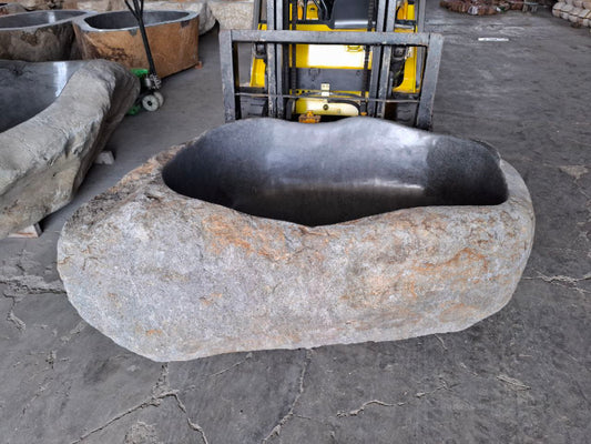 Top view of freestanding river stone bathtub