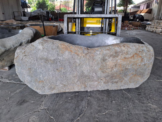 Side angle showing rugged natural stone exterior