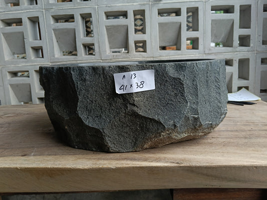 Front view of 6A13-4138 andesite vessel basin — polished organic interior