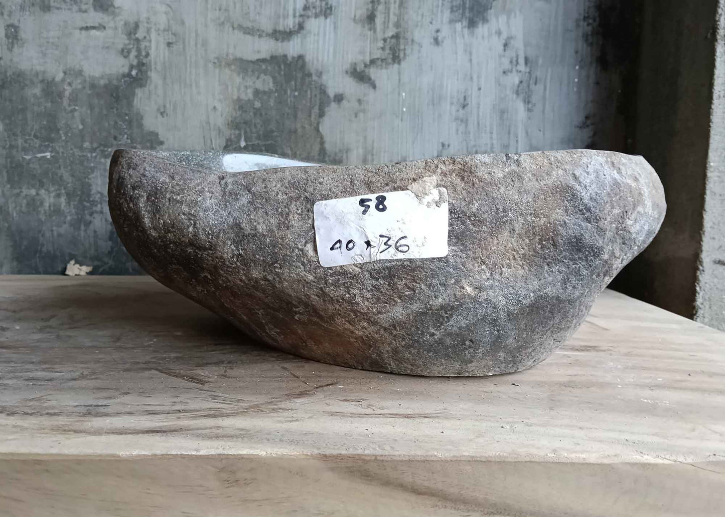 Right side view of irregular 16×14 inch river stone sink in gray textured stone
