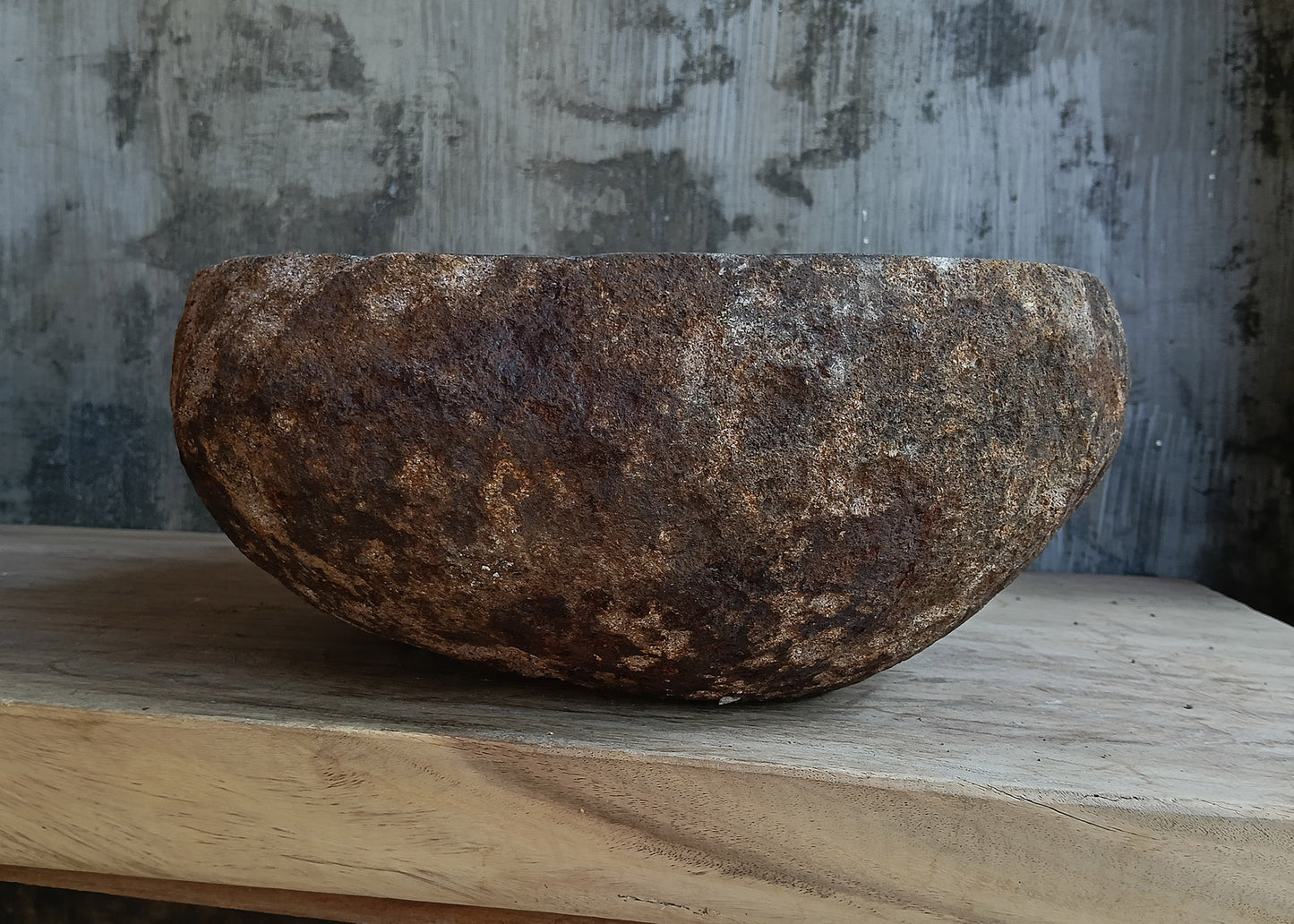 Right side view of oval dark brown river stone basin 6600-1824 with rough exterior