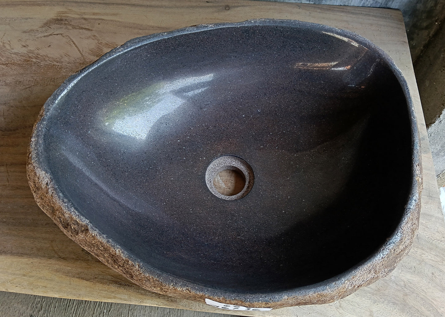 Top view of oval dark brown river stone sink 6600-1824 with polished interior
