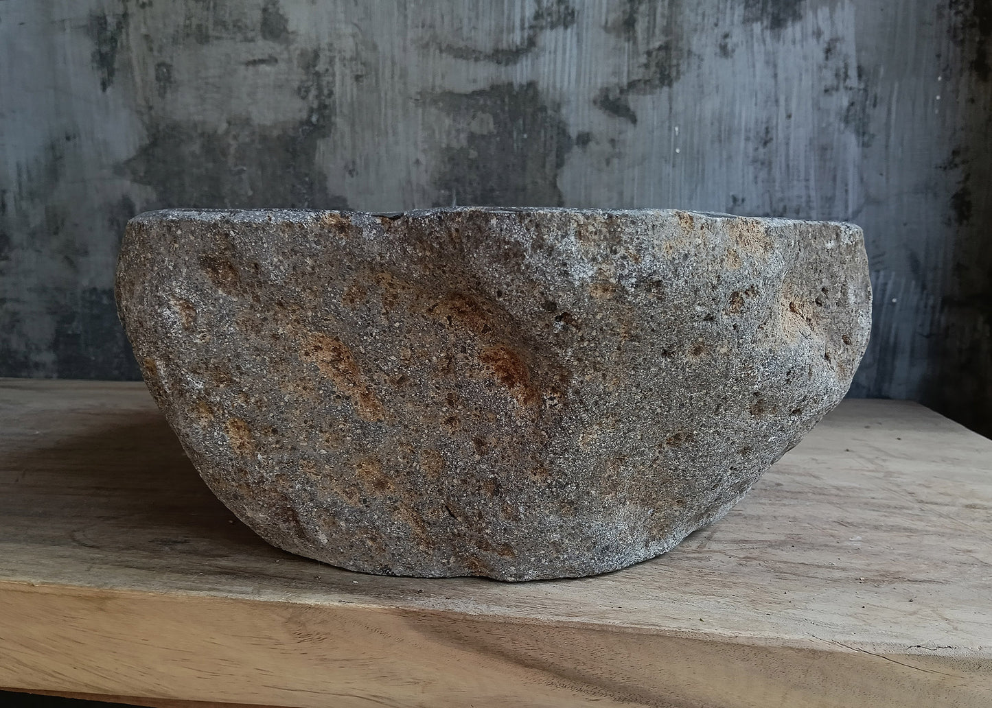 Left side view of irregular dark gray river stone sink 6646-4134 with rough exterior