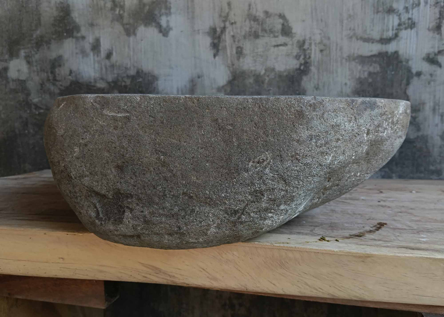 Left side view of oval dark gray river stone sink 6648-5145 with rough exterior