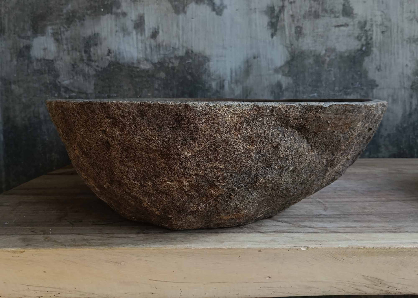 Left side view of oval light brown river stone sink 6656-5643 with rough exterior