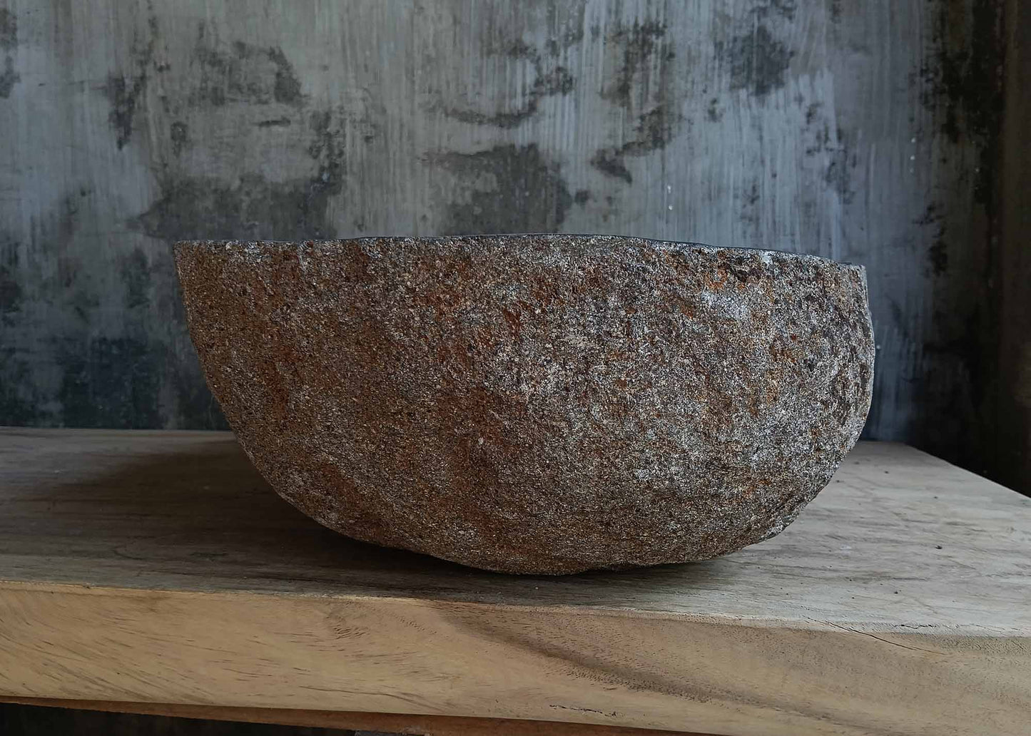 Left side view of oval dark gray river stone sink 6666-4835 with rough exterior