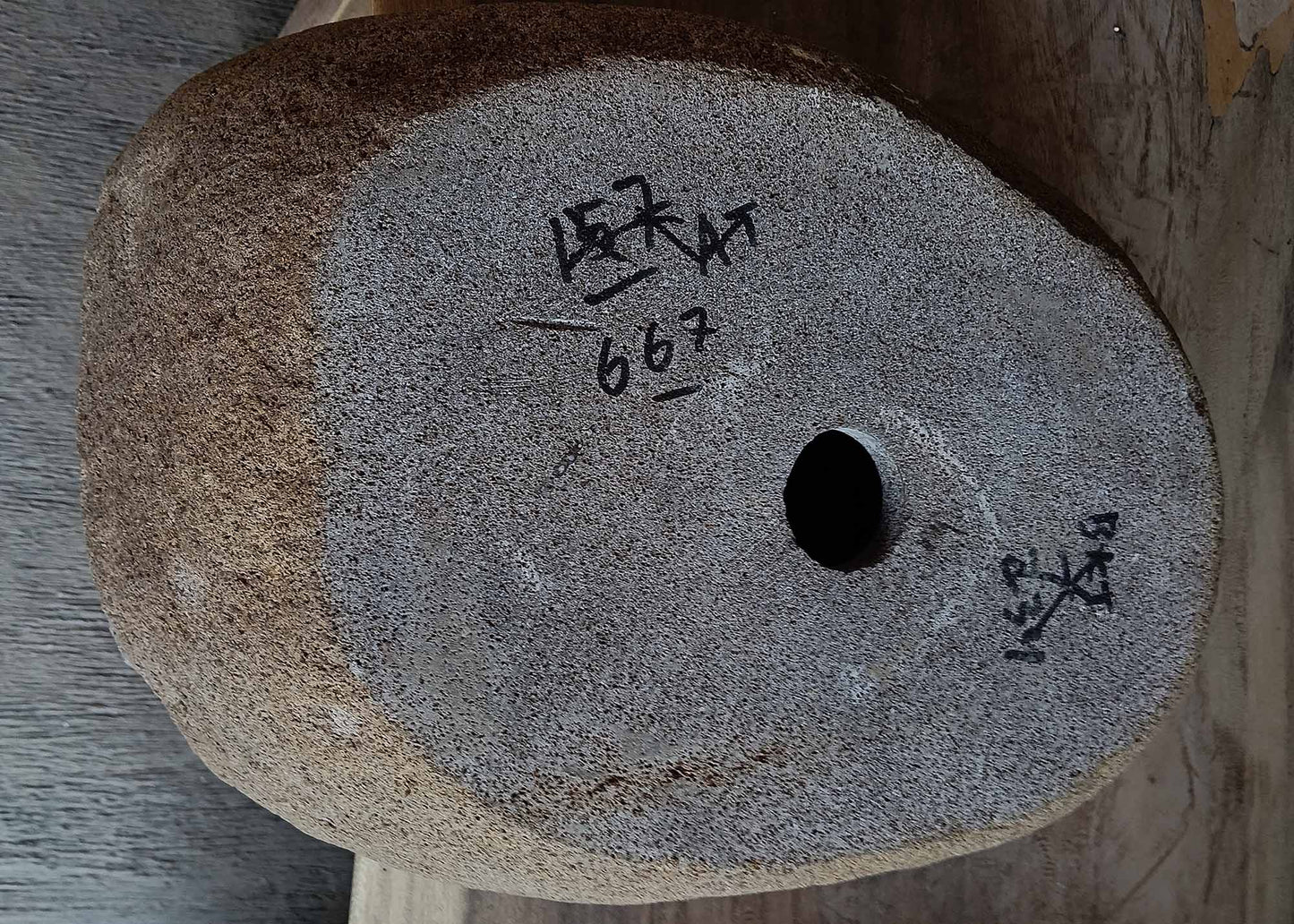 Bottom view of handcrafted oval dark gray river stone sink 6667-4633