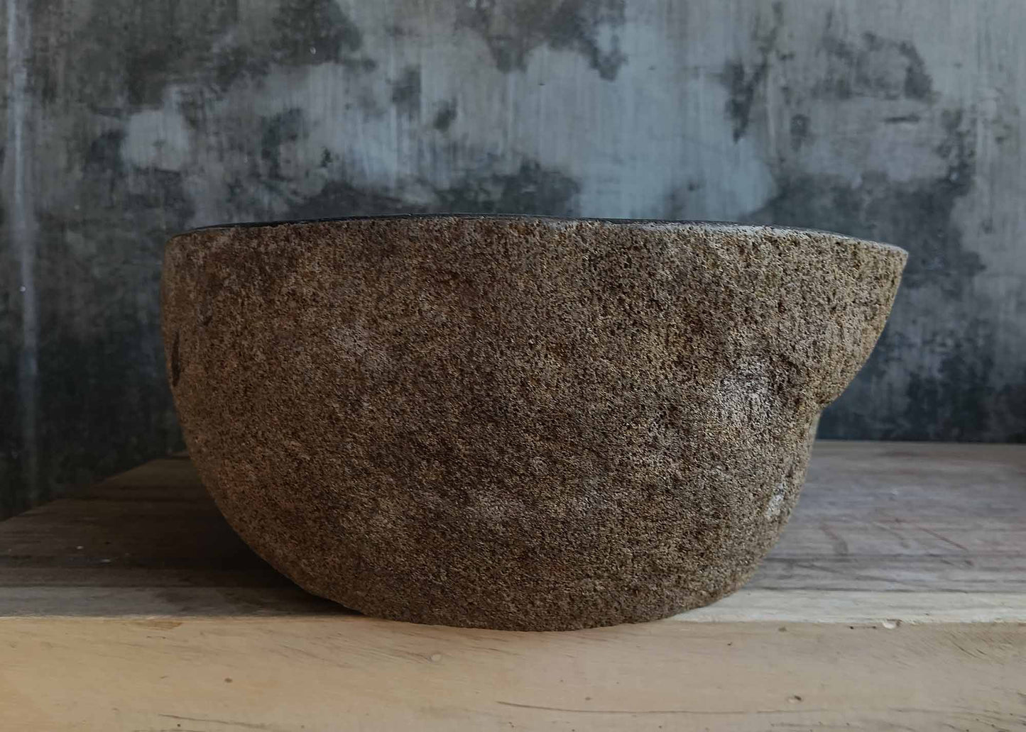 Left side view of oval dark gray river stone sink 6667-4633 with rough exterior