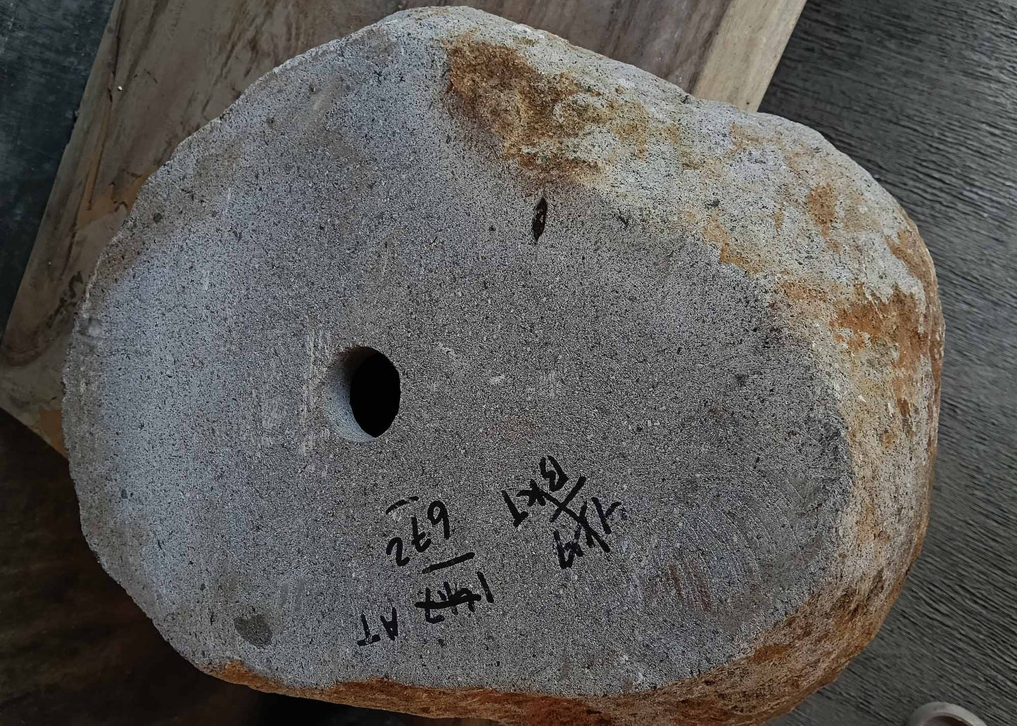 Bottom view of handcrafted river stone sink 6672-4939 showing drain hole placement