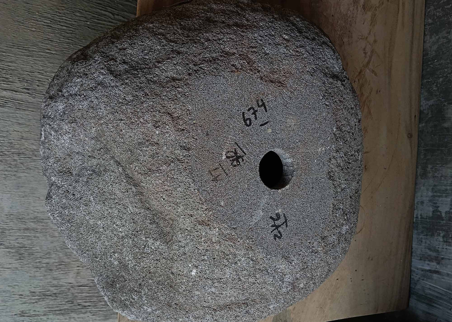 Bottom view of irregular dark gray river stone sink 6674-4542 showing raw stone base