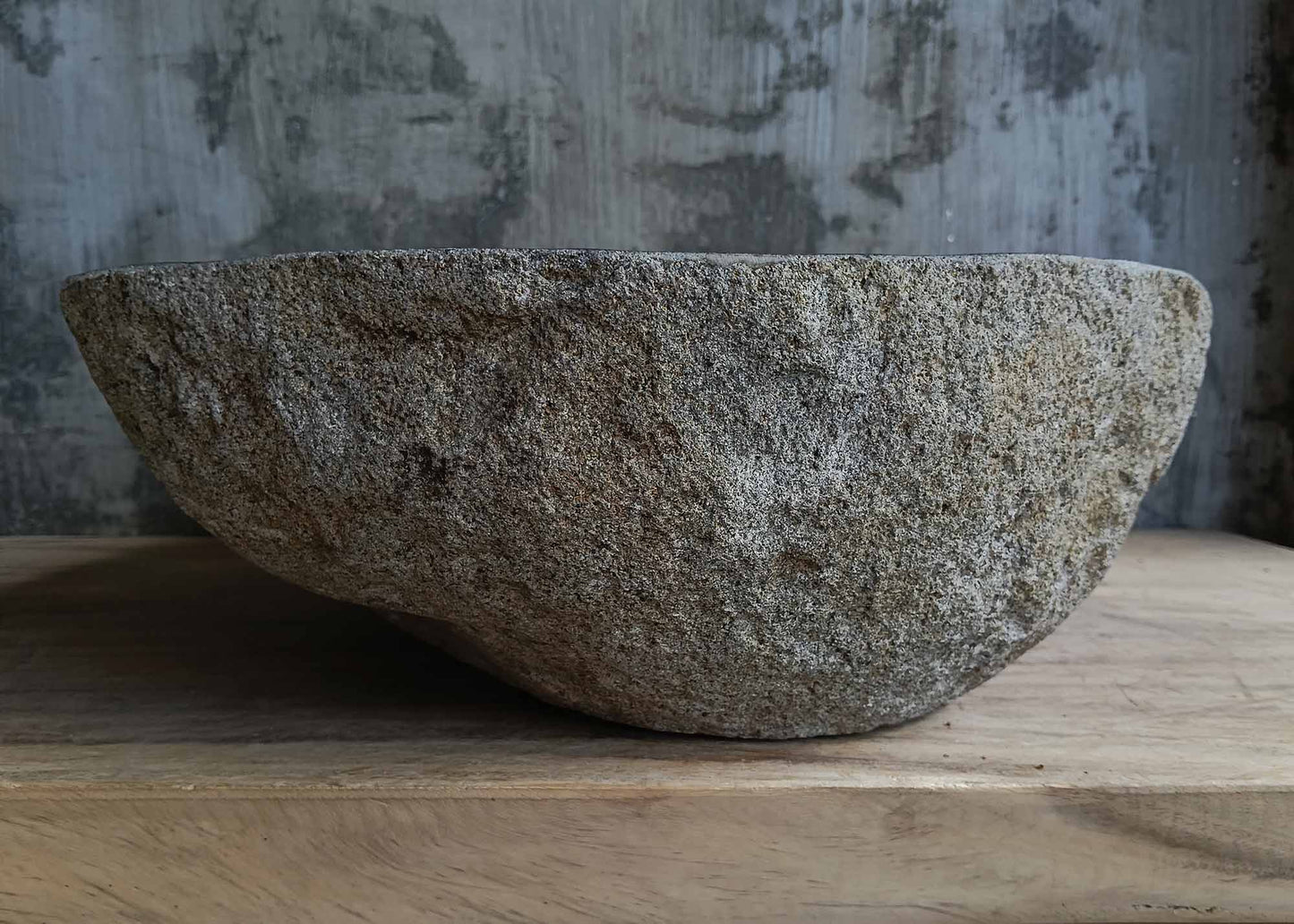 Left side view of handcrafted dark gray river stone sink 6676-5343 with organic shape