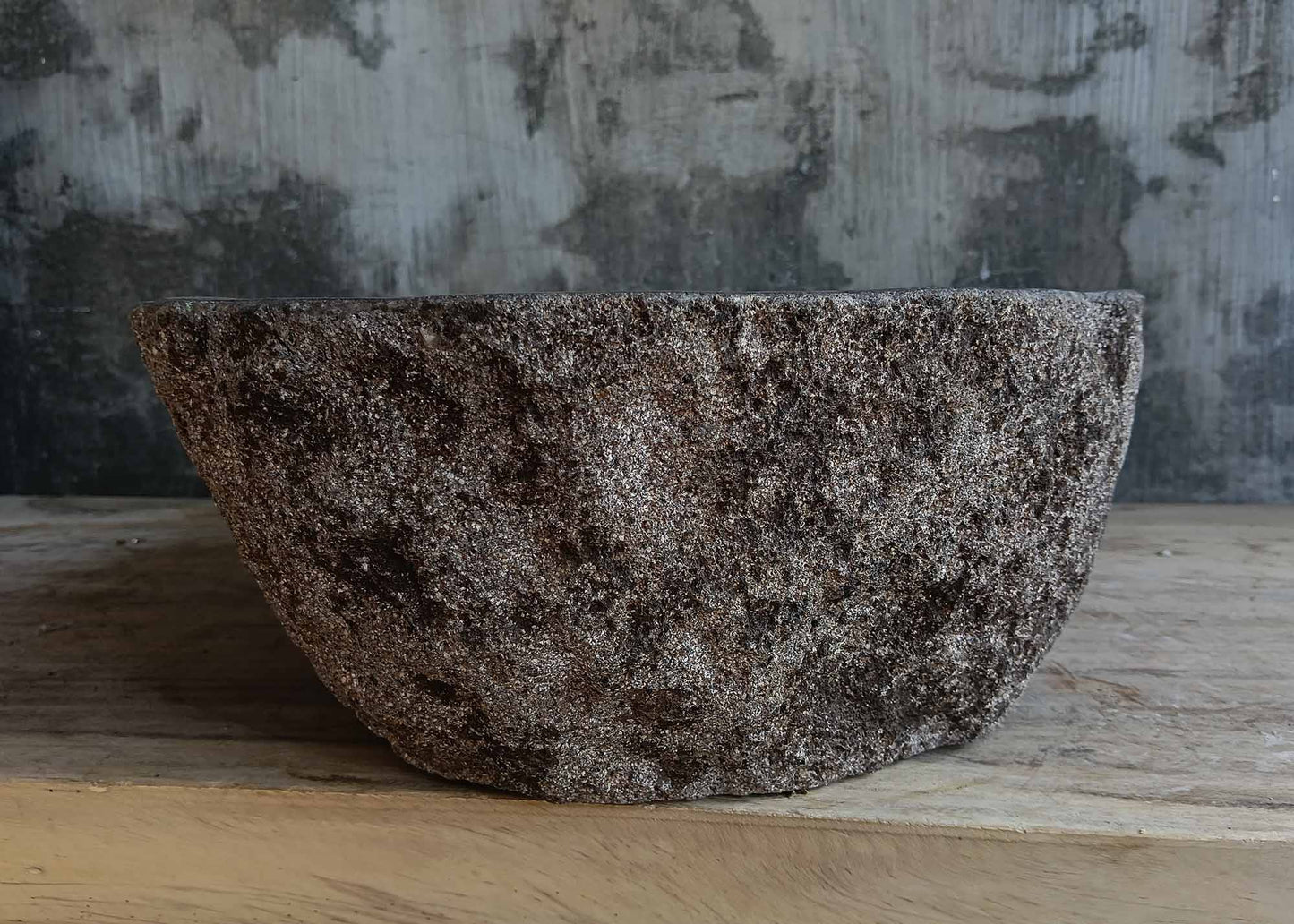 Right side view of handcrafted dark gray river stone sink 6677-4335 with rustic stone texture