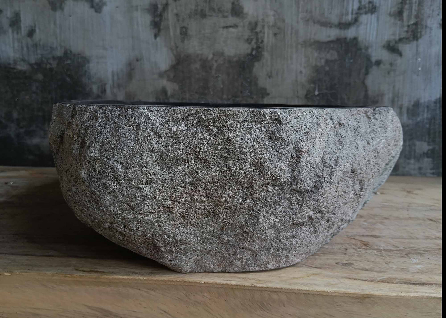 Right side view of handcrafted dark gray river stone sink 6678-4337 with rustic stone texture