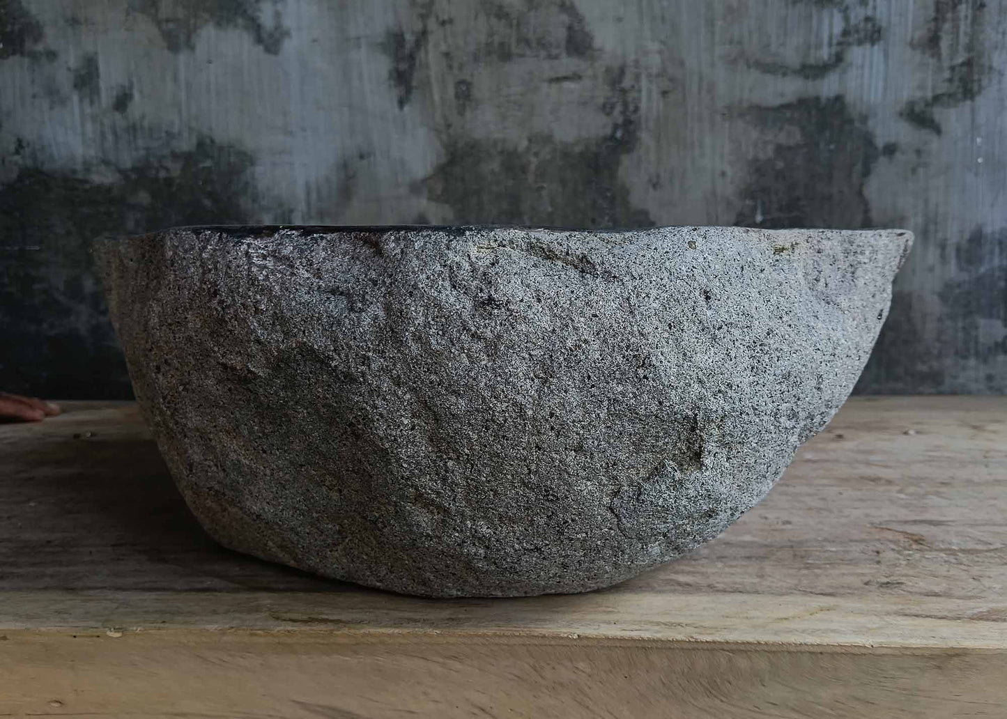 Back view of handcrafted dark gray river stone sink 6678-4337 with textured stone surface