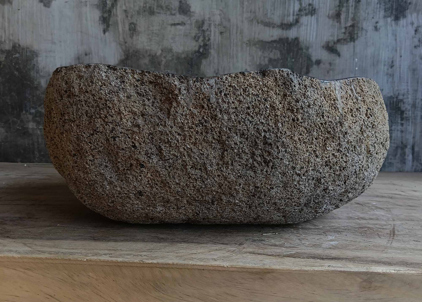 Back view of handcrafted light brown river stone sink 6680-3731 with textured stone surface