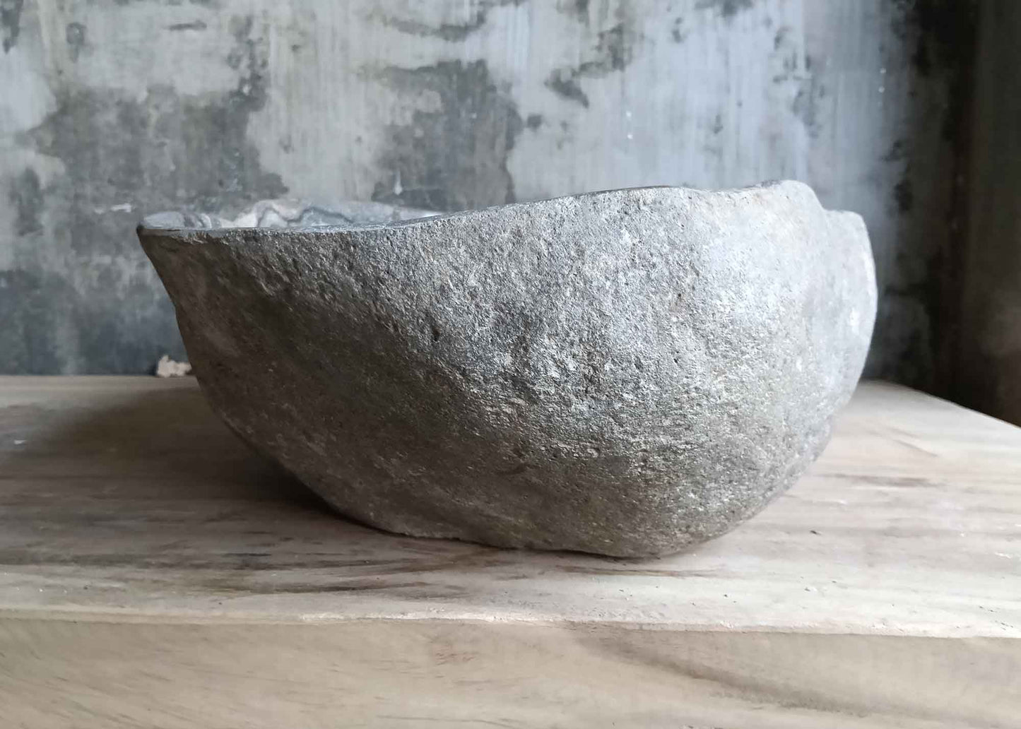 Right side view of mixed-tone river stone sink featuring rare mineral veins and raw exterior