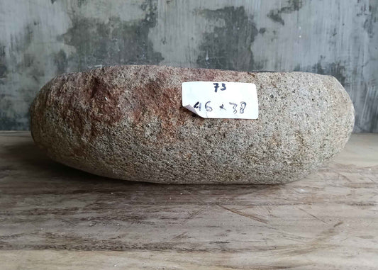 Back side view of 18×15 inch handcrafted river stone sink with natural outer surface