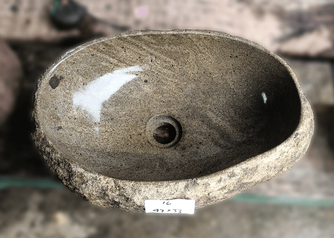 Top view of handcrafted light brown 18×13 inch river stone sink with speckled finish