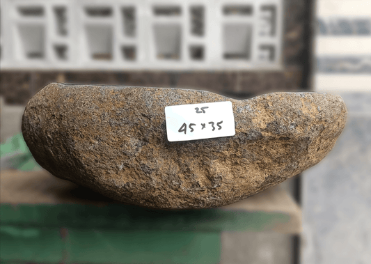 Side view of 18×14 inch river stone sink installed in countertop, showing oval shape and dual-tone finish